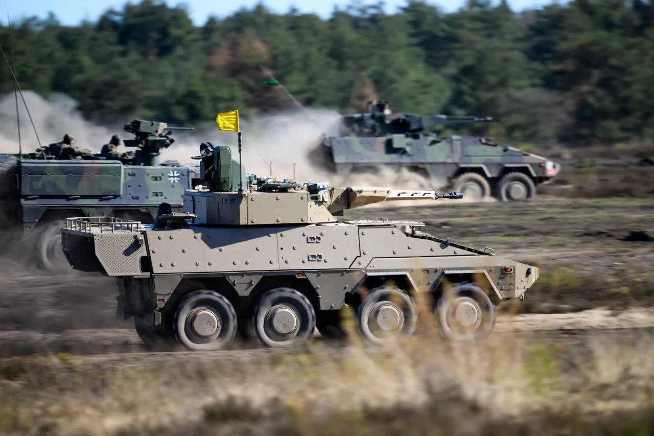 Boxer tanks of the German army operate during a presentation at the German army barracks while the German Chancellor (unseen) visits the troops of the German Army in Munster, northern Germany, on April 30, 2026. (Photo by DANIEL REINHARDT / AFP)