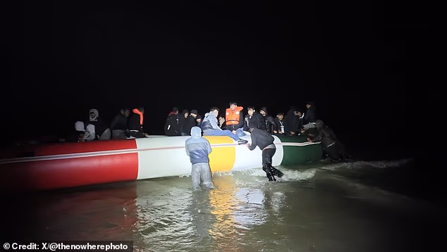 More than 20 men were filmed on the dinghy off a Belgian beach early on Thursday, watched by police