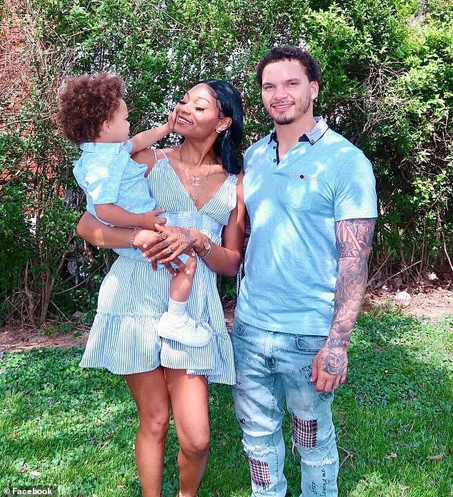 Police said that Baker had argued with his girlfriend Raneka Pate, seen here holding their late son Kentre, after coming out as gay. The family are seen here in a social media photo