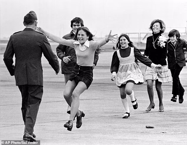 Lorrie Kitching, pictured with her arms outstretched, was 15 years old in 1973 when her father, Lt Col Robert Stirm, returned home from Vietnam after spending almost five years as a prisoner of war