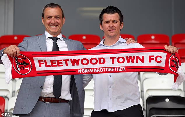 Mr Pilley pictured holding a club scarf with Joey Barton when he became manager of Fleetwood Town