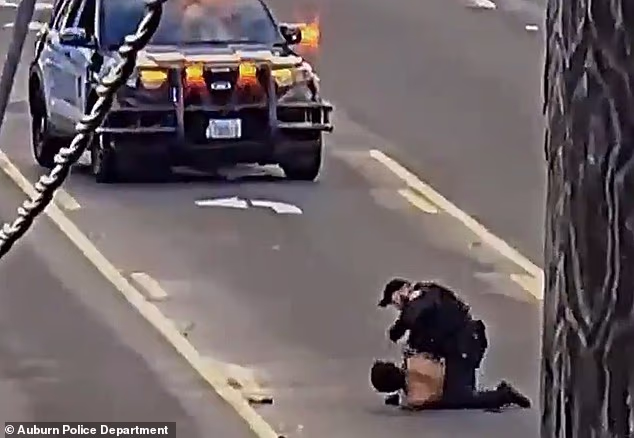 Traffic camera footage shows Bryant straddling Valles and repeatedly punching him in the head as the two struggle in the middle of the road
