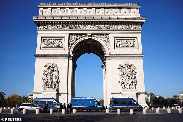 Police vans are pictured in front of the Arc de Triomphe on the day of a protest organised by labour unions as part of nationwide protests