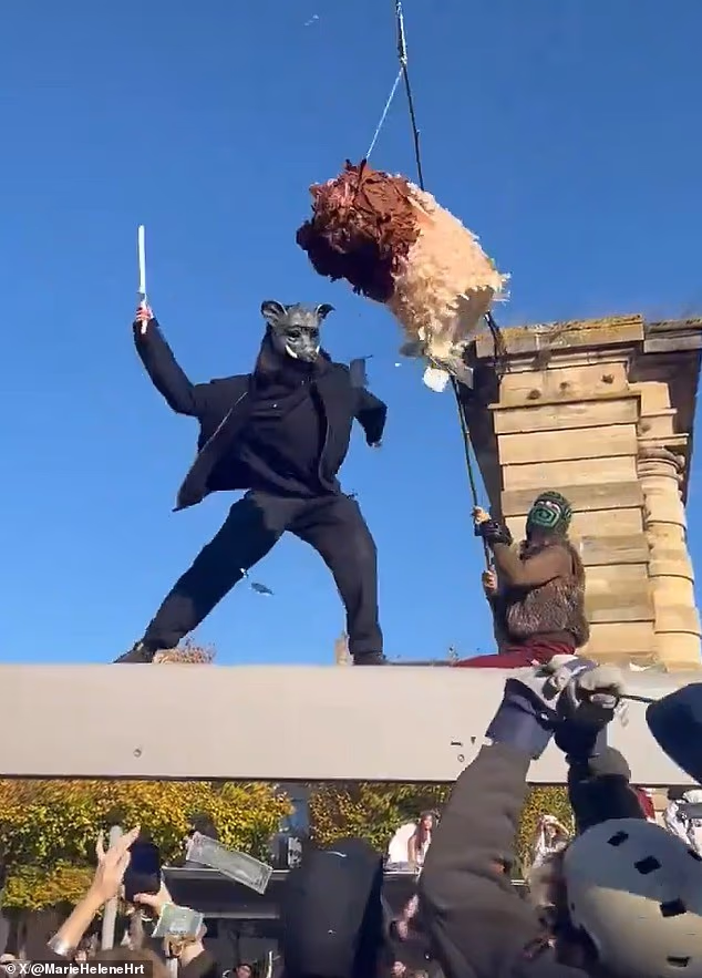 Masked protesters smashed apart an effigy of Macron and hurled firebombs at police as violent clashes erupted across France on Saturday
