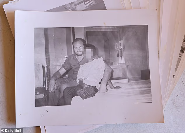 Among the photos in the unit is an undated image of Markle on a bed and with his arm wrapped around a young Asian female, both fully clothed. She appears, alone and naked, in several other pictures as well