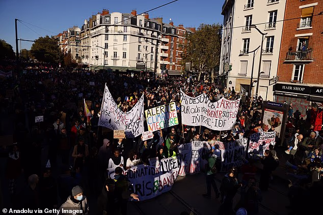 Demonstrators carrying banners, flags and various costumes, take part in a protest by the Gilets jaunes (Yellow Vests) movement on at Porte de Bagnolet